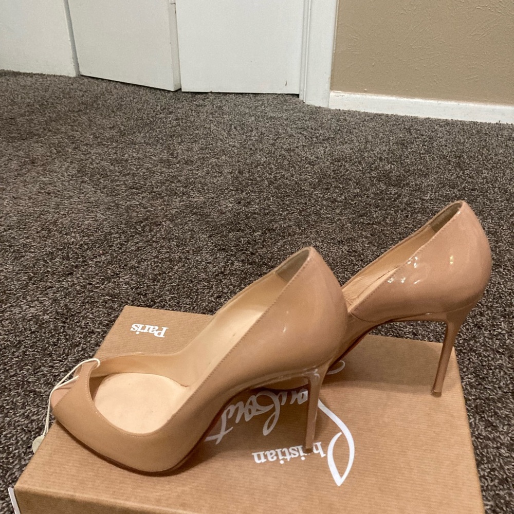 Authentic  Cristian Louboutin size 7 nude Peep toe Heels. 4 inches
